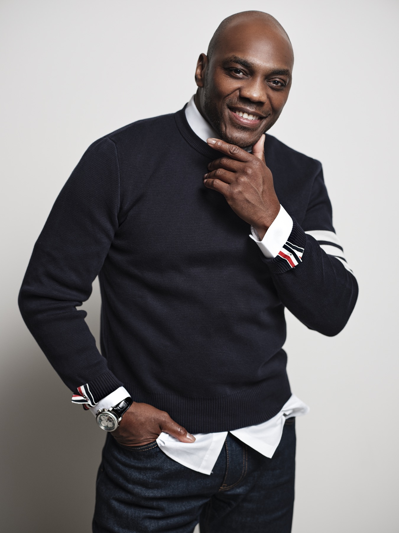 Tello smiling in a warm comedian portrait